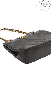 Sold Attire black quilted lambskin matelasse chain tote with gold-tone hardware and chain strap.