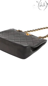 Sold Attire black quilted lambskin matelasse chain tote with gold-tone hardware and chain strap.