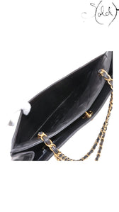 Sold Attire black quilted lambskin matelasse chain tote with gold hardware and open top construction.
