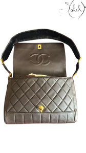 Sold Attire chocolate brown quilted lambskin Chanel Classique Single Full Flap bag with 24k gold-plated CC turn-lock and suede strap.