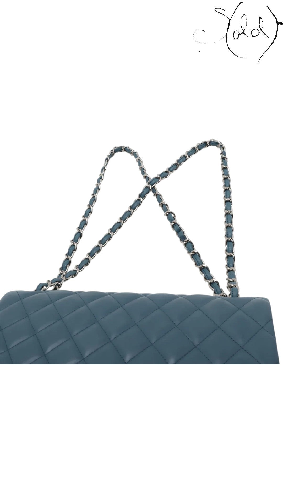 Sold Attire blue lambskin quilted 30 double flap Chanel bag with silver chain strap.