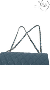 Sold Attire blue lambskin quilted 30 double flap Chanel bag with silver chain strap.