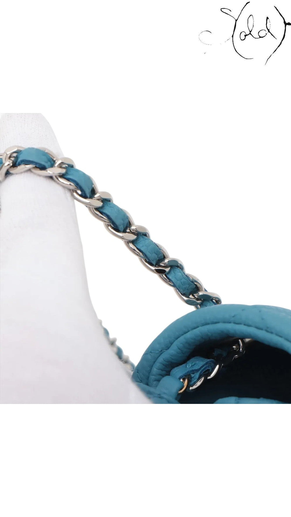 Sold Attire blue quilted caviar leather Chanel Extra Mini Classic Flap bag with silver-tone hardware and chain strap.