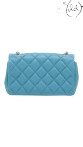 Sold Attire blue quilted caviar leather Chanel Extra Mini Classic Flap bag with silver-tone hardware and chain strap.