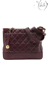 Sold Attire bordeaux lambskin Chanel Matelasse Chain Tote with gold hardware and Coco Ball charm, circa 1991.