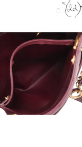 Sold Attire Chanel Matelasse Chain Tote in bordeaux lambskin with gold hardware and Coco Ball charm, circa 1991.