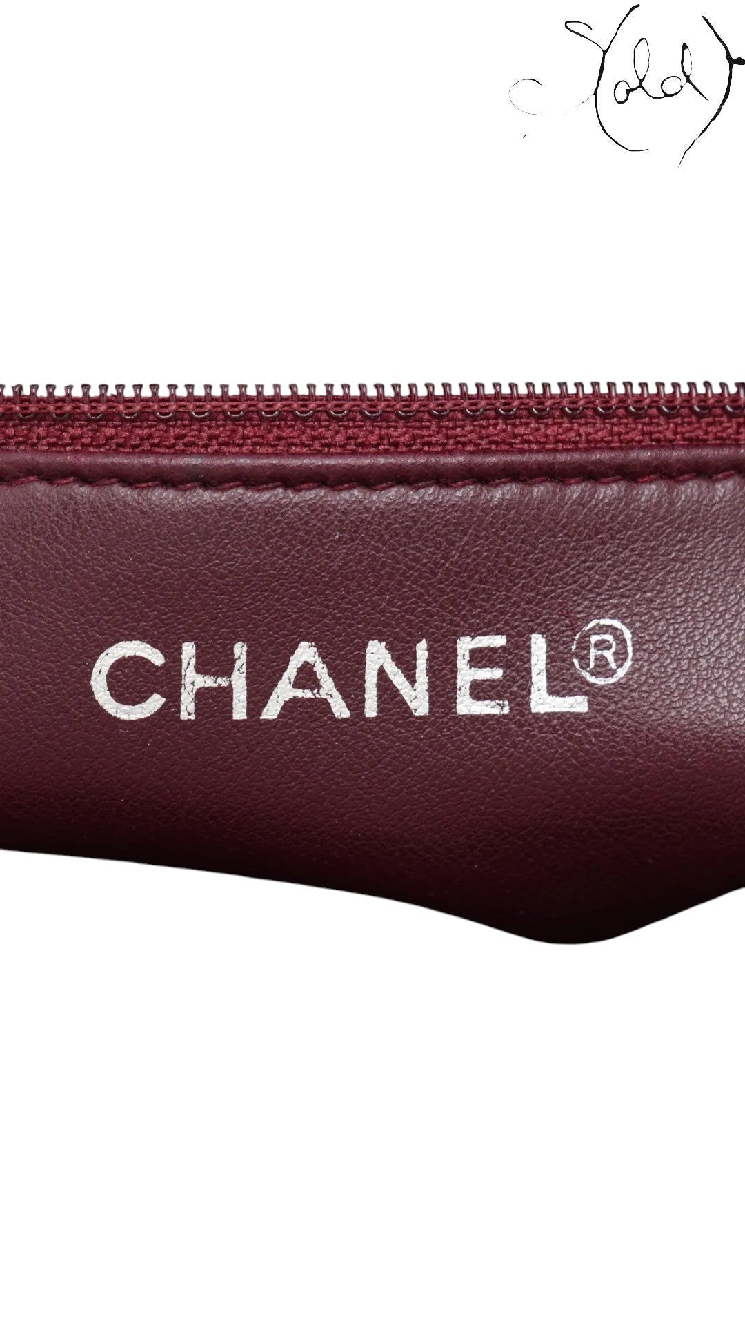 Sold Attire Chanel Matelasse Chain Tote in bordeaux lambskin with gold hardware and Coco Ball charm, circa 1991.