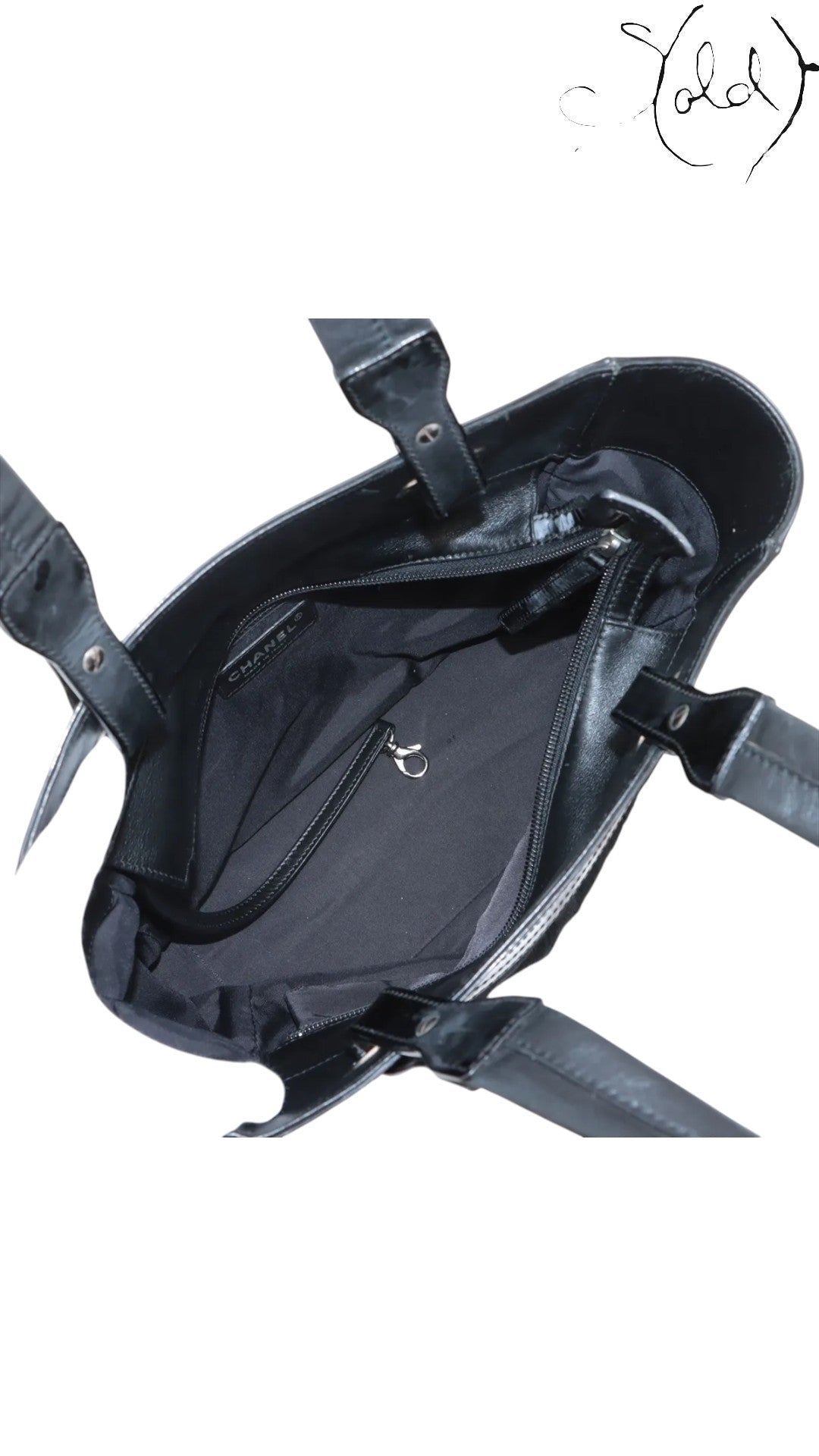 Sold Attire black Chanel Paris-Biarritz PM tote bag made of quilted pony hair and patent leather with silver-tone hardware.