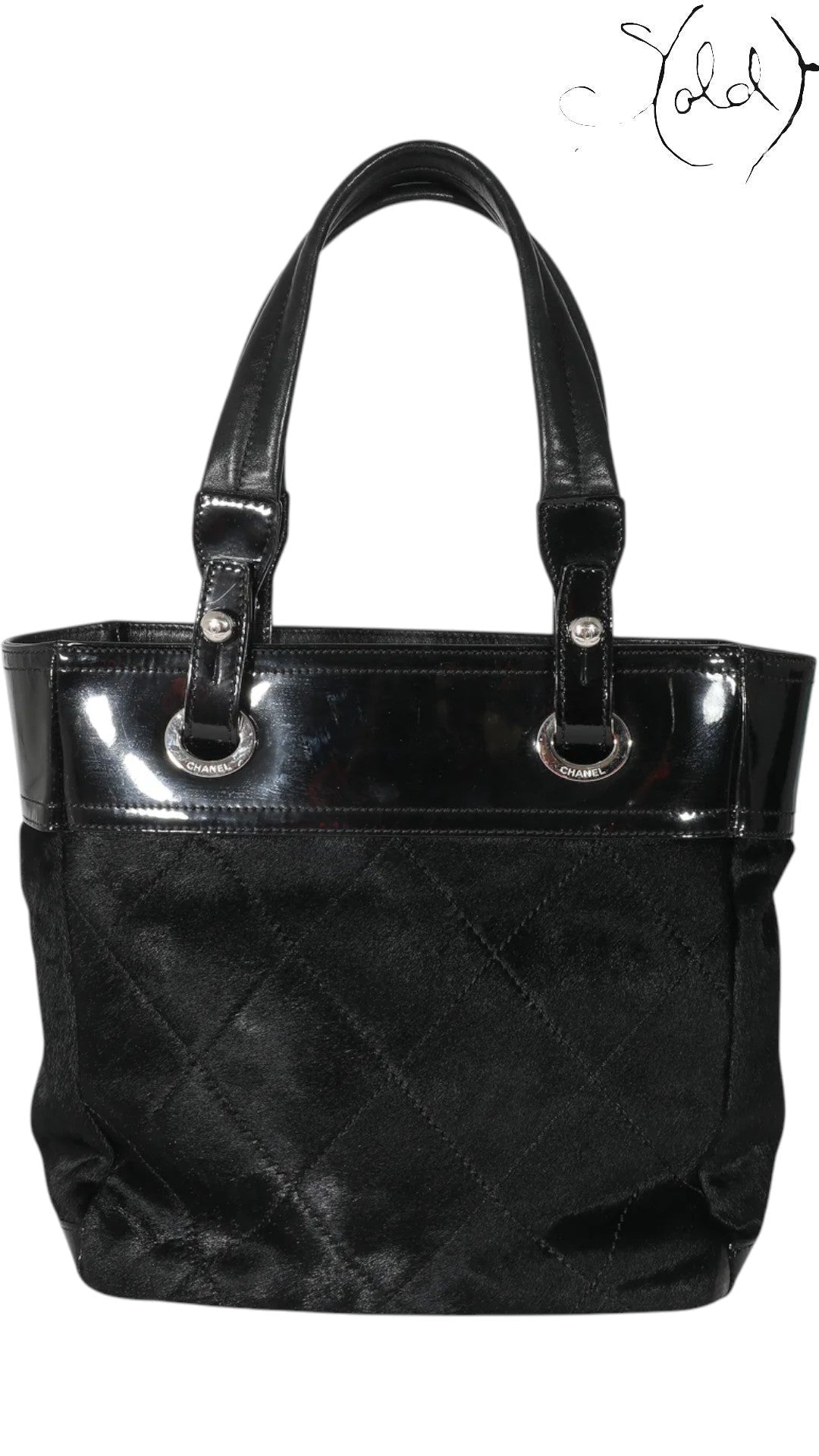 Sold Attire black Chanel Paris-Biarritz PM tote bag with quilted pony hair body and patent leather trim.
