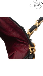 Sold Attire vintage Chanel bag interior featuring burgundy leather lining and gold-tone leather-woven chain strap