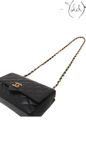 Sold Attire vintage Chanel black quilted lambskin single flap bag featuring a crystal CC turn-lock and gold chain strap.