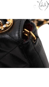 Sold Attire vintage Chanel black quilted lambskin single flap bag featuring a crystal CC turn-lock and gold hardware.