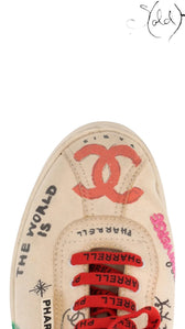 Sold Attire Chanel x Pharrell low-top canvas sneakers in white with multicolor graphic prints and red branded laces.