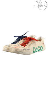 Sold Attire Chanel x Pharrell low-top canvas sneakers in white with multicolor COCO print and mismatched laces.