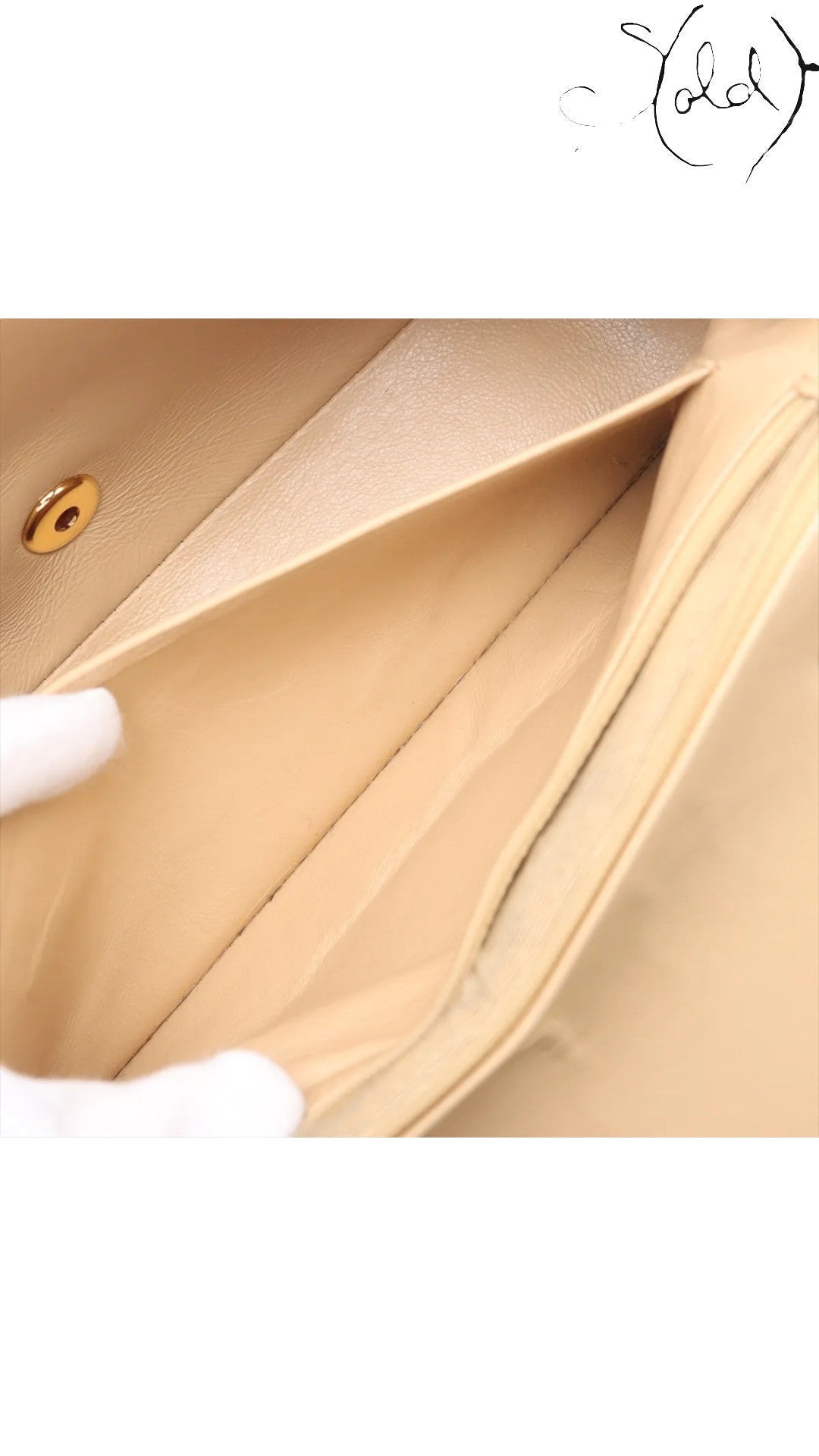 Sold Attire beige lambskin Chanel Diana medium bag interior with gold hardware closure detail.