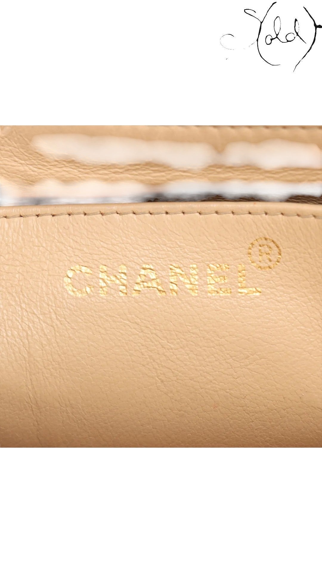 Sold Attire beige lambskin Chanel Diana Medium bag interior with gold embossed Chanel logo and registered trademark symbol.