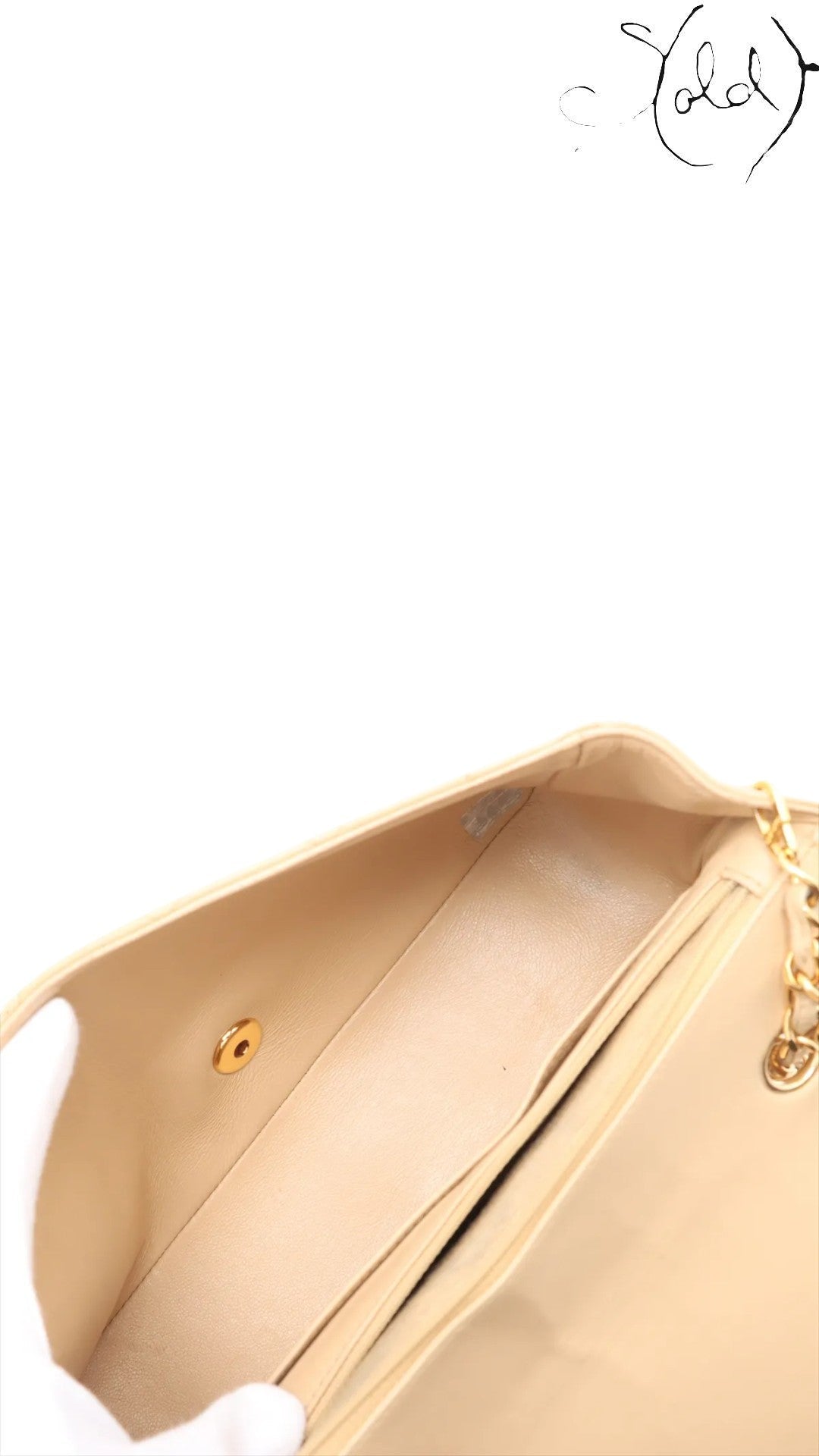 Sold Attire beige lambskin Chanel Diana medium bag interior with gold hardware turn-lock closure and chain strap.