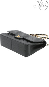 Sold Attire black caviar leather Chanel Jumbo Classic Double Flap bag with gold hardware and chain strap.