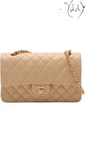 Sold Attire beige lambskin Chanel Medium Classic Double Flap bag with gold hardware and chain strap, featuring diamond quilting and a CC turnlock closure.
