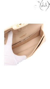 Sold Attire beige lambskin Chanel Medium Classic Double Flap bag interior with gold hardware and CC turnlock.