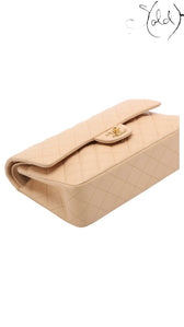 Sold Attire beige lambskin Chanel Medium Classic Double Flap bag with gold hardware and diamond quilting.