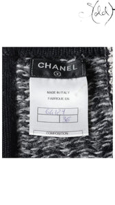 Sold Attire black wool pencil skirt, size FR 38, with Chanel logo and composition label.