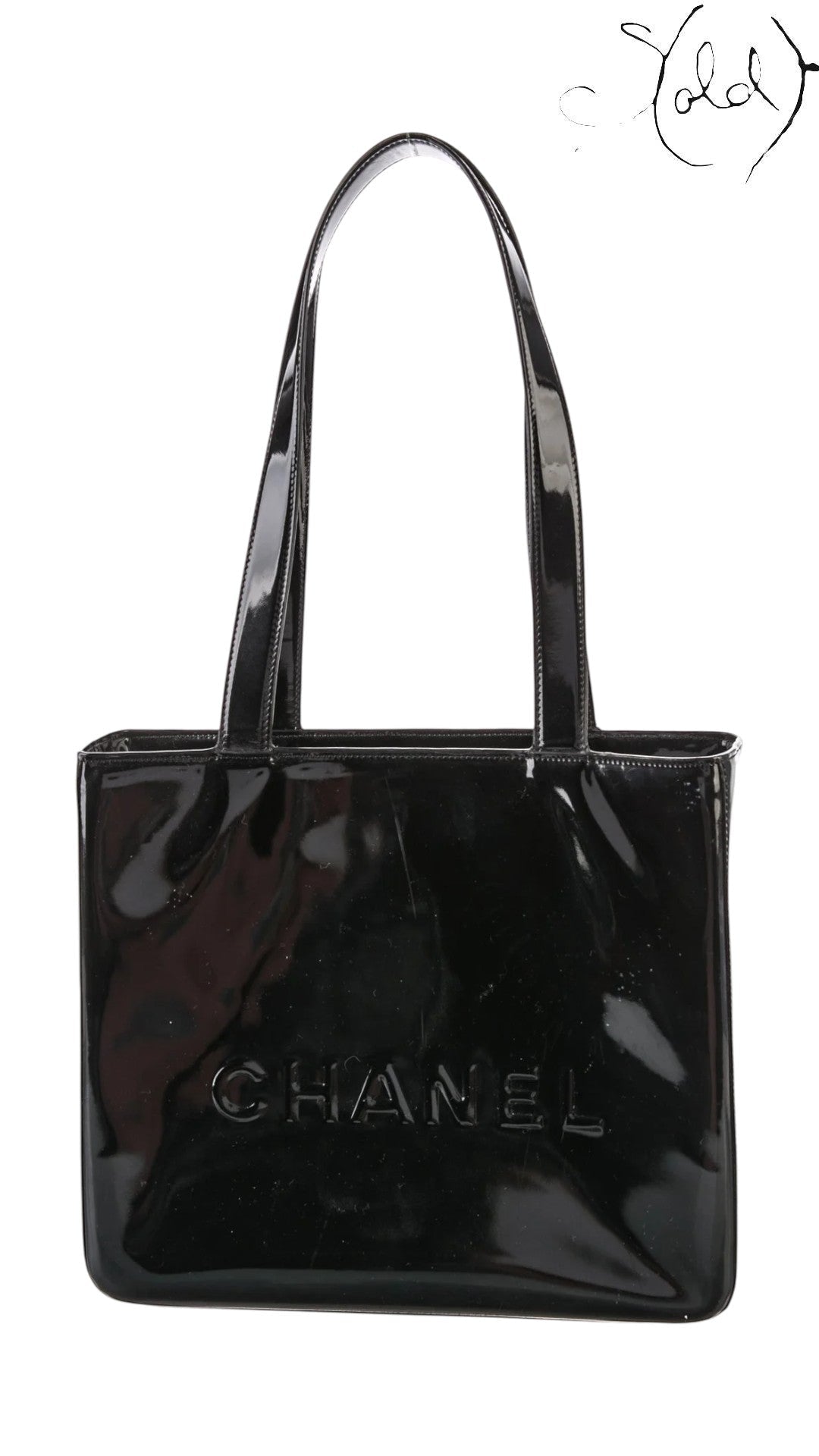 Sold Attire black patent leather tote bag with gold hardware and embossed Chanel logo. Early 2000s.