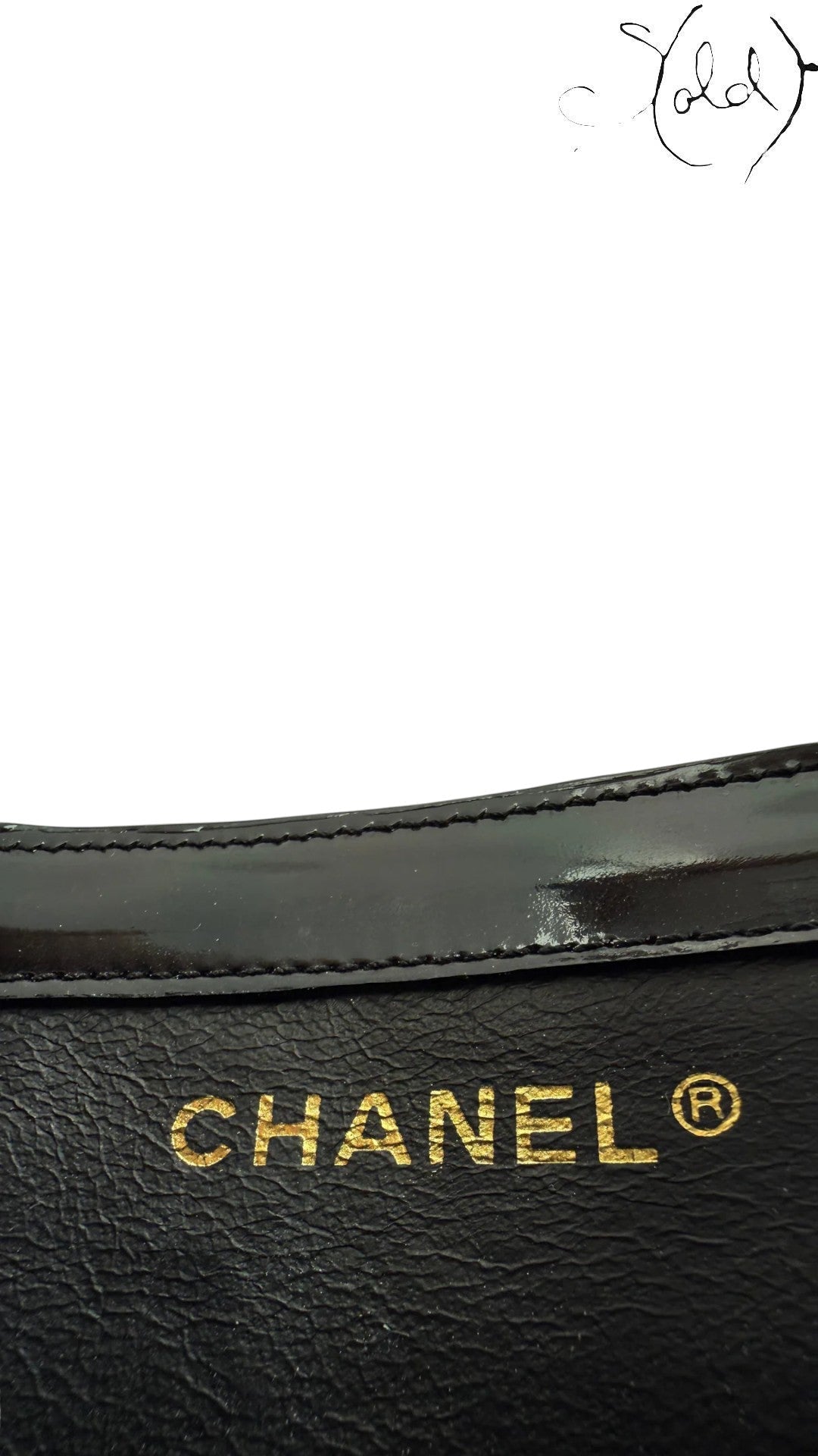 Sold Attire black patent leather Chanel tote with gold hardware and embossed logo.