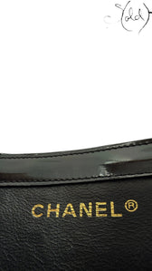 Sold Attire black patent leather Chanel tote with gold hardware and embossed logo.