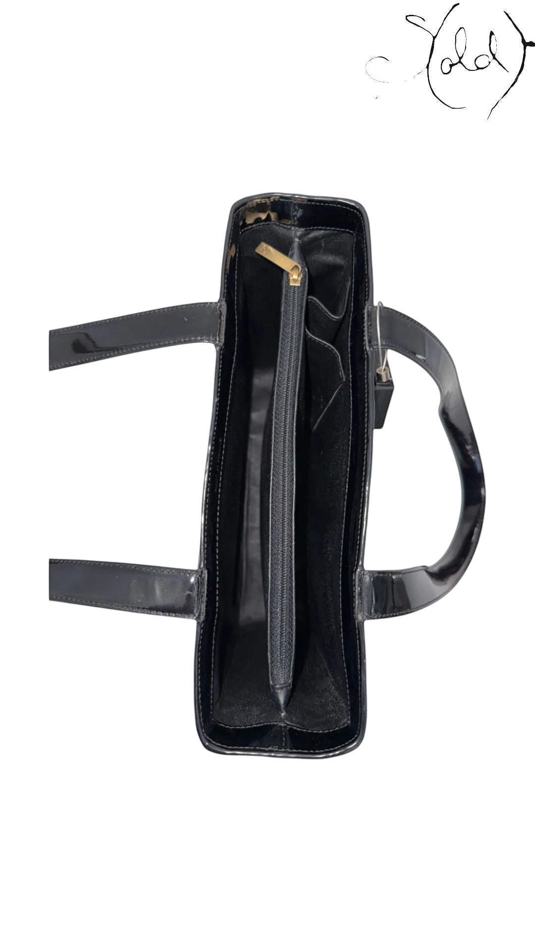 Sold Attire black patent leather tote with gold hardware and interior zip pocket. Early 2000s Karl Lagerfeld design.