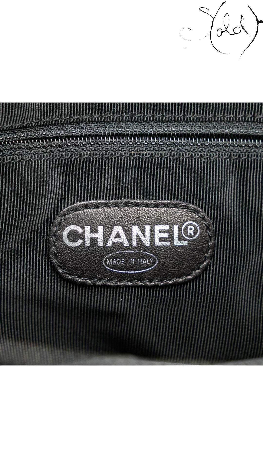 Sold Attire black caviar leather Chanel CC tote with silver-tone hardware and quilted detail.