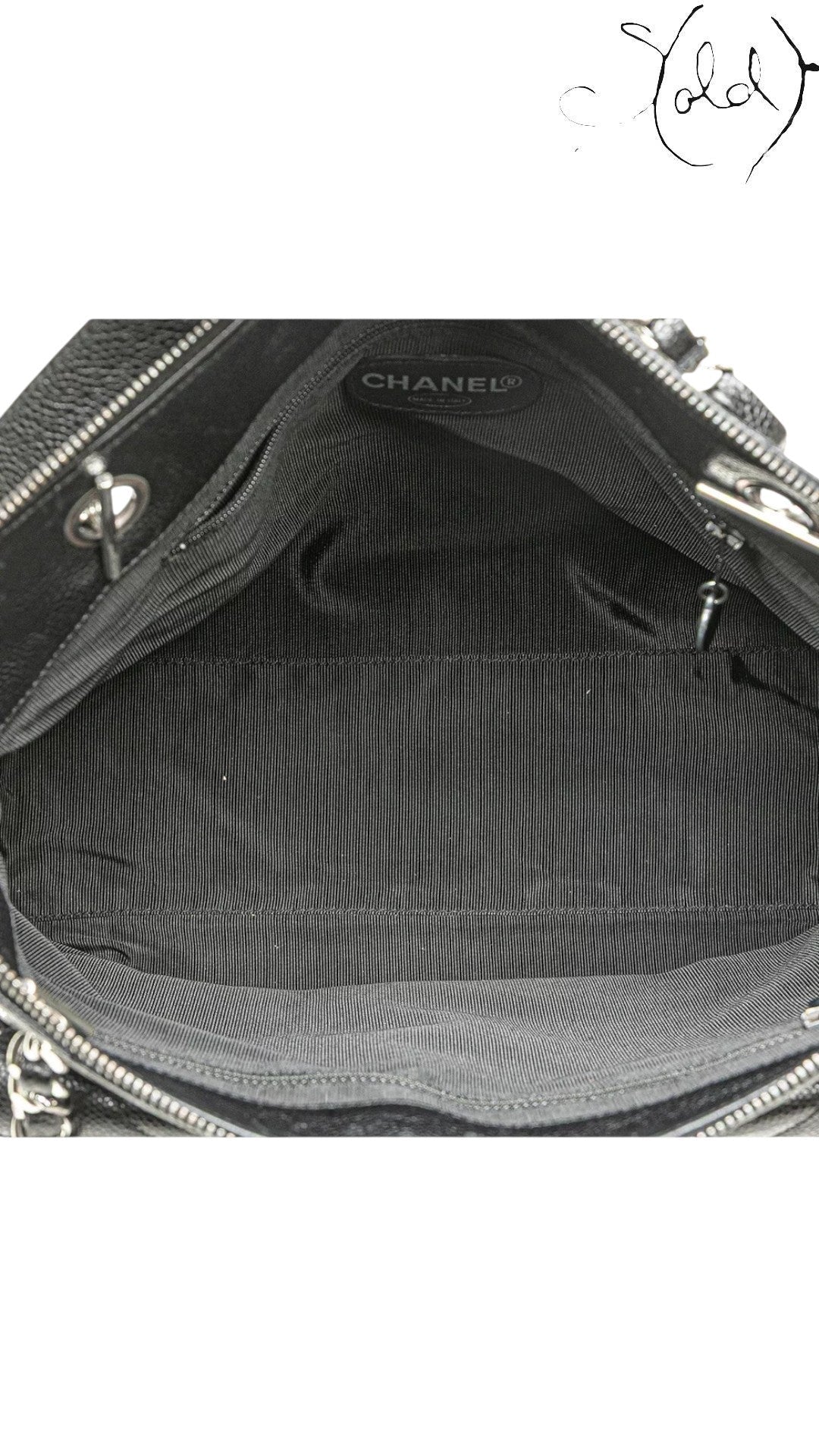 Sold Attire black quilted caviar leather Chanel CC tote with silver-tone hardware and striped lining.