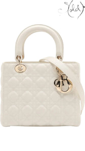 Sold Attire white lambskin Lady Dior medium bag with rose gold hardware and D.I.O.R. charms, featuring cannage quilting.