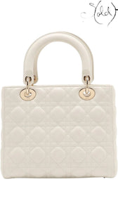 Sold Attire medium white lambskin Lady Dior bag with rose gold hardware and cannage quilting.