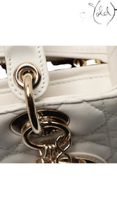 Sold Attire: White lambskin Dior Lady Dior medium bag with rose gold hardware and cannage quilting.