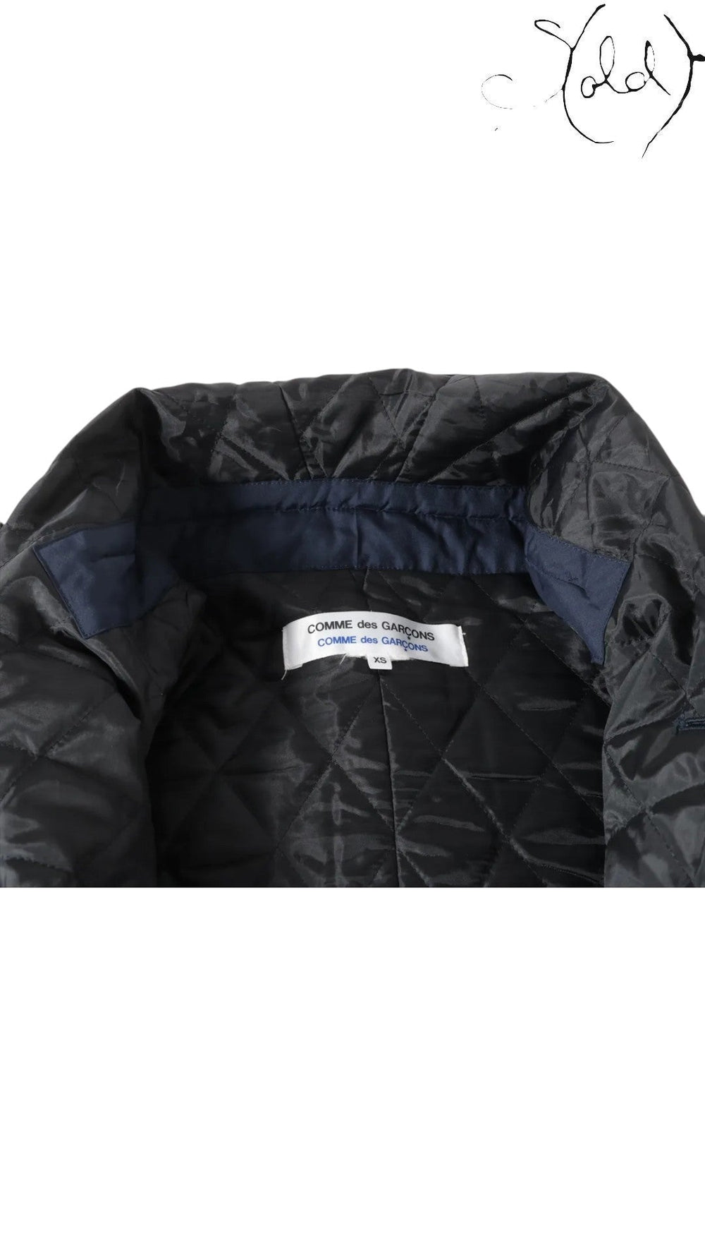 Sold Attire navy polyester padded cape coat with quilted lining and navy collar detail. Features Comme des Garçons label.