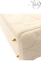 Sold Attire ivory Dior Lady Dior handbag featuring signature Cannage quilted leather and gold-tone protective feet.