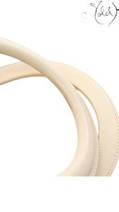 Sold Attire ivory leather top handles of a Dior Lady Dior handbag with smooth stitching and structured design