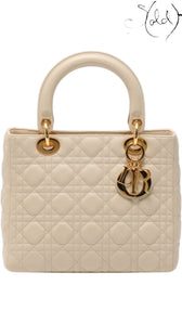 Sold Attire ivory Lady Dior handbag in quilted Cannage leather with gold-tone hardware and signature Dior letter charms.