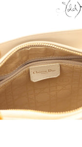 Sold Attire interior view of an ivory Lady Dior handbag showing the Christian Dior Paris leather tag and zip closure.