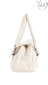 Side view of a cream leather Dior Saint Germaine flap bag with silver-tone hardware from Sold Attire