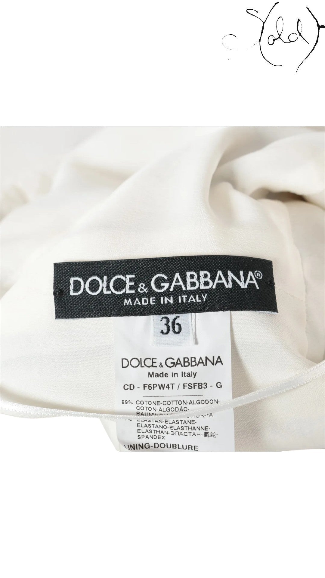 Sold Attire: Dolce & Gabbana white sleeveless dress with a vibrant wisteria print and black and white striped bodice. Made in Italy, size 36.