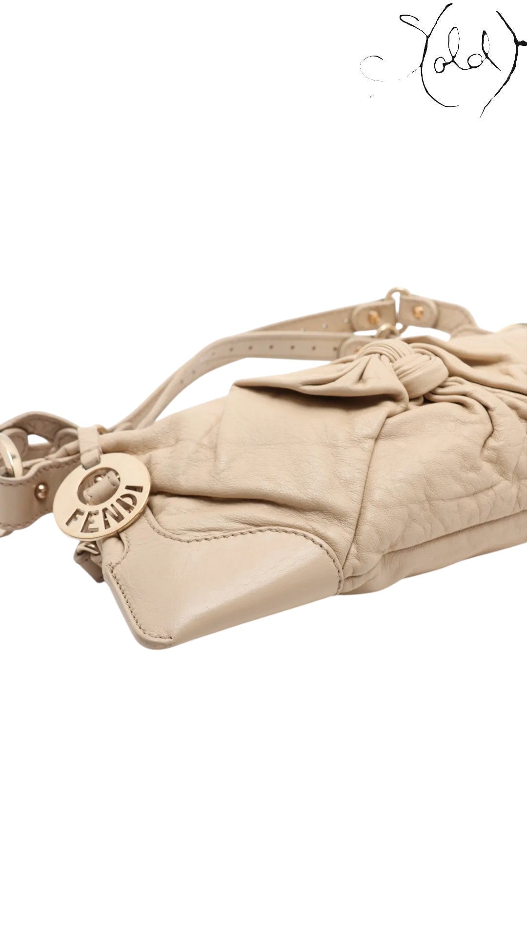 Sold Attire beige leather Fendi Knot shoulder bag with gold-tone Fendi logo charm and knotted detail.