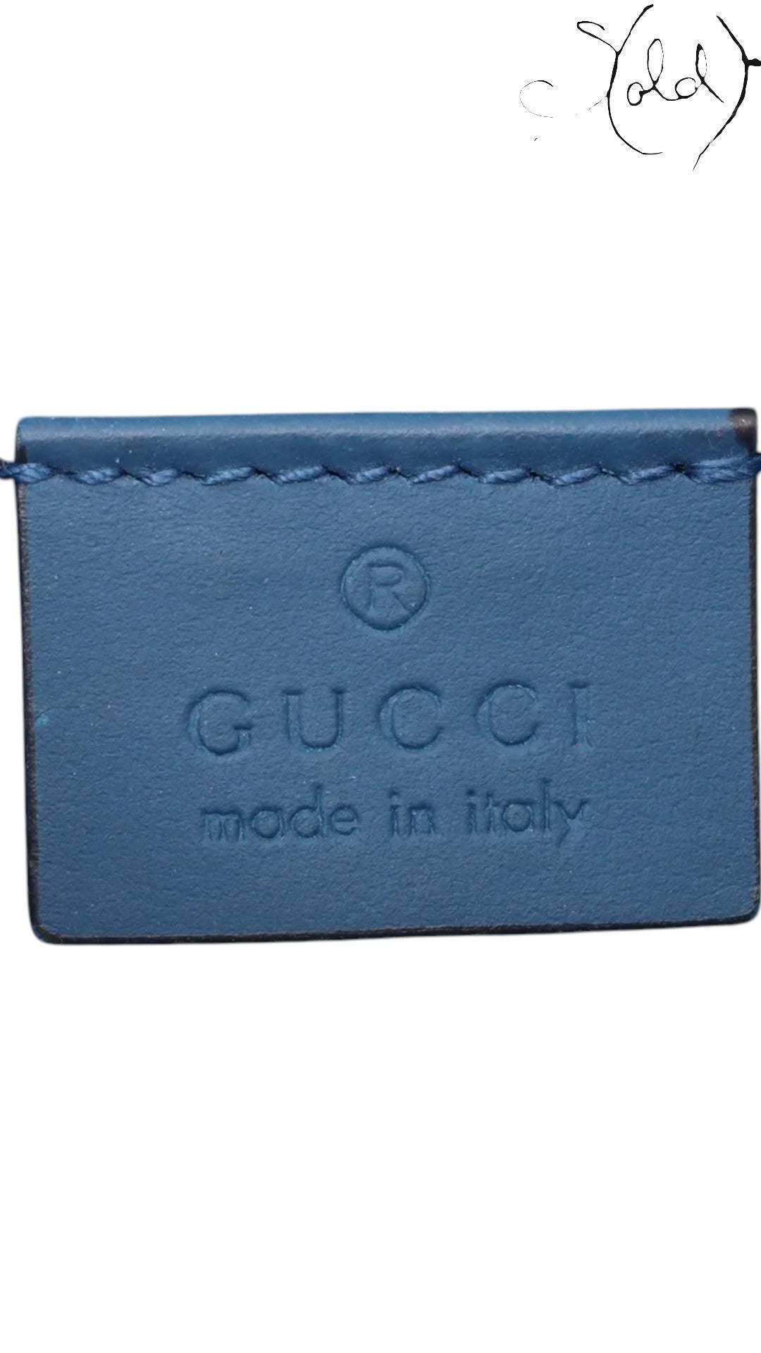 Sold Attire: Close-up of blue suede interior with Gucci made in Italy leather tag.