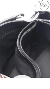 Sold Attire interior view of a black Gucci 00s GG Supreme shoulder bag showing the textile lining and zip pocket.