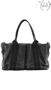 Sold Attire black Veau Derma leather Hermès Caravan Horizontal MM tote bag with silver hardware and contrast stitching.