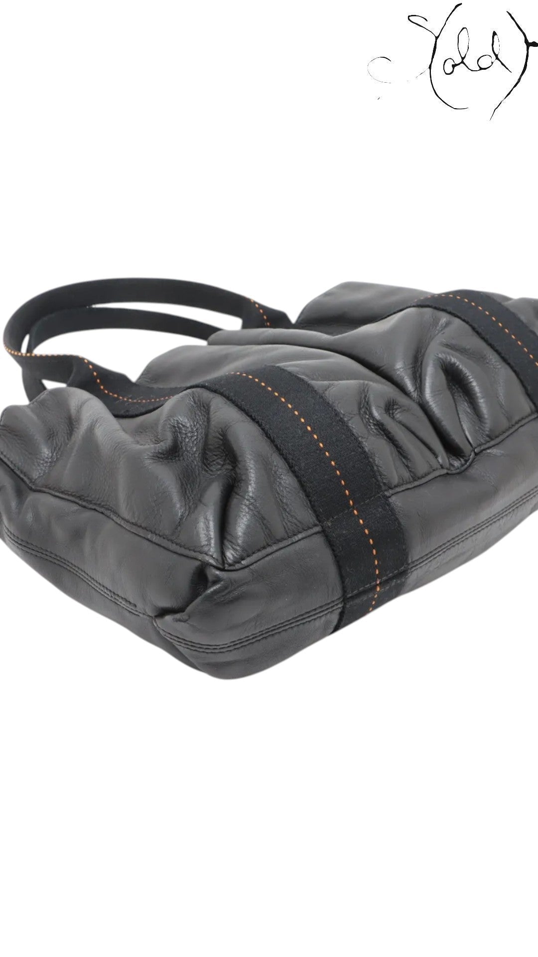 Sold Attire black Veau Derma leather Hermès Caravan Horizontal MM tote with silver hardware and orange contrast stitching.