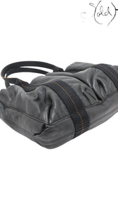Sold Attire black Veau Derma leather Hermès Caravan Horizontal MM tote with silver hardware and orange contrast stitching.