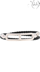 Sold Attire: Hermès Roulis Double Tour bracelet in black Swift calfskin with palladium-plated hardware. Wraps twice around the wrist.