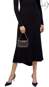Sold Attire model holding a brown Louis Vuitton Monogram Mini Pochette Accessoires with brass chain handle and zip top.